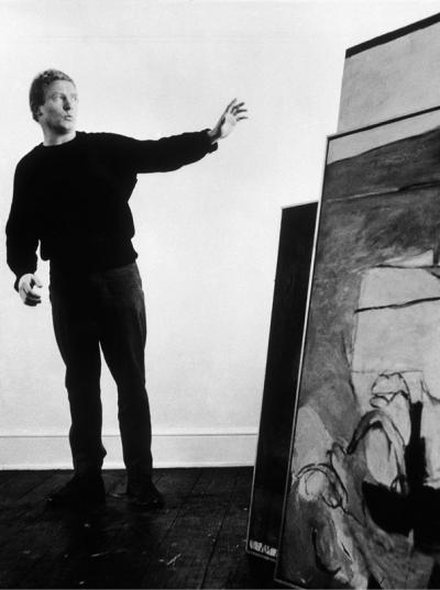 <p>Whiteley aged 22 in his Ladbroke Grove Studio standing beside <em>Untitled Warm Painting</em></p>